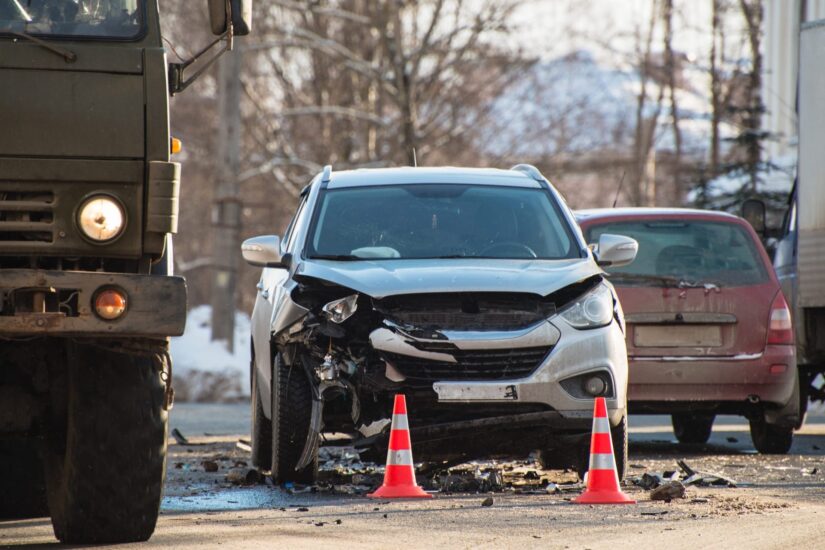 A silver car with damaged front