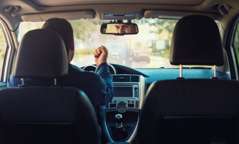 Person showing his fist to the front driver