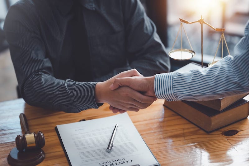 Attorney and client shaking hands