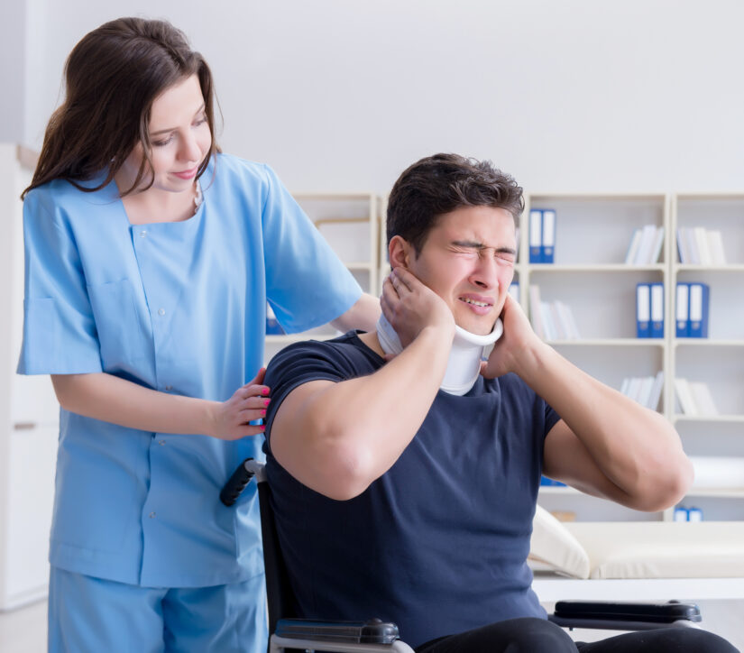 A man holding his neck in pain at the doctors
